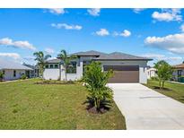 Charming single-Gathering home featuring a well-maintained lawn, two-car garage, and inviting curb appeal at 12396 Bacchus Rd, Port Charlotte, FL 33981