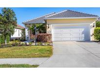 Charming single-story home with a two-car garage and well-manicured landscaping at 12717 Deep Blue Pl, Bradenton, FL 34211