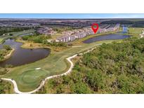 Aerial view of a residential community on a golf course with pond and manicured lawns at 17626 Gawthrop Dr # 305, Bradenton, FL 34211