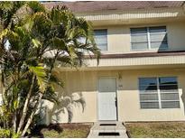 Inviting front entrance featuring well-maintained landscaping, offering a warm welcome to this charming home at 306 Barlow Ave # 77, Sarasota, FL 34232