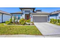 Charming home featuring a well-manicured lawn and a two-car garage in a suburban neighborhood at 3663 Quiet Dr, Sarasota, FL 34240