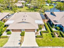 Stunning aerial view of villa with meticulous landscaping, serene water features, and community pool, offering an inviting neighborhood at 4451 Atwood Cay Cir # 7, Sarasota, FL 34233