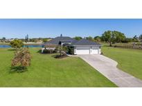 Well maintained ranch home with mature landscaping and a long driveway with a 3-car garage at 4606 Lake Fox Pl, Parrish, FL 34219