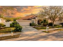 Inviting single-story home with an attached two-car garage, complemented by a well-manicured front yard and beautiful landscaping at 4706 Cayo Costa Pl, Bradenton, FL 34203
