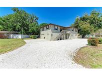 Charming two-story home with a front yard featuring white gravel and a convenient attached garage at 5311 San Jose Dr, Sarasota, FL 34235