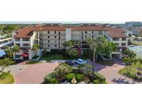 A beautiful condominium featuring lush landscaping, ample parking, and a well-maintained exterior at 6263 Midnight Pass Rd # 301, Sarasota, FL 34242