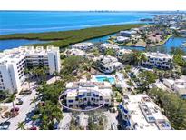 Aerial view showcases this waterfront condo community with a pool and stunning views of the bay at 1928 Harbourside Dr # 1403, Longboat Key, FL 34228