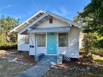 Charming home with a bright turquoise door and well-maintained front yard, creating an inviting curb appeal at 2530 9Th W Ave, Bradenton, FL 34205