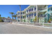 Beautiful three story waterfront home with multiple balconies and a well manicured fenced front yard at 314 Bay S Dr # 5, Bradenton Beach, FL 34217