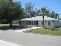 Charming single-story home with a lush lawn and a metal roof, offering great curb appeal at 361 Yorkshire St, Port Charlotte, FL 33954