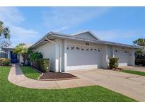 Inviting single-story home featuring a well-maintained lawn, two-car garage, and charming curb appeal at 4201 Center Gate Ln # 1, Sarasota, FL 34233