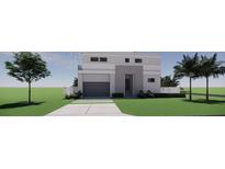 Modern two-story home featuring a gray exterior, a two-car garage, and clean landscaping at 610 Hibiscus Way, Longboat Key, FL 34228