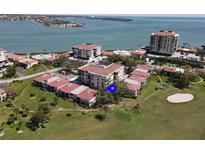 An aerial view of a waterfront condo complex, a golf course, and intercoastal waterway at 6269 Palma Del Mar S Blvd # 308, St Petersburg, FL 33715
