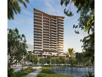 Stunning high-rise building featuring balconies, modern architectural details, and lush landscaping at 668 Quay Commons # 1401, Sarasota, FL 34236