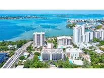 Stunning aerial view of waterfront condos with bay views and boat dotted harbor at 755 S Palm Avenue # 604, Sarasota, FL 34236