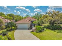 Well maintained property showing driveway, landscape, and roof at 7847 Chick Evans Pl, Sarasota, FL 34240