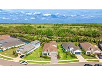 An aerial view showing the property situated on a well-maintained lot, featuring a landscaped yard at 10165 Canaveral Cir, Sarasota, FL 34241