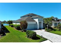 Beautiful single-Gathering home boasts lush landscaping, a paver driveway, and an attached two-car garage at 10527 Falling Leaf Ct, Parrish, FL 34219