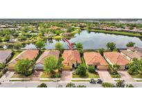 Beautiful single-Gathering home with terracotta roof tiles, surrounded by a lush green landscape and stunning water views at 12711 Del Corso Loop, Bradenton, FL 34211