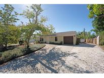 Charming single-story home featuring a well-kept lawn and a brown garage door at 2316 Bradford St, Sarasota, FL 34231