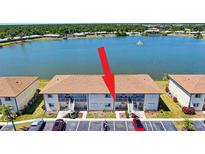 Waterfront condo building with lush landscaping and ample parking at 25275 Rampart Blvd # 1203, Punta Gorda, FL 33983