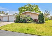 Charming single-story home featuring mature landscaping and an attached two-car garage at 3328 Dartmouth Ln # 1012, Sarasota, FL 34239