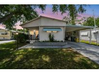 Charming single-story home featuring a covered carport and well-maintained landscaping, perfect for comfortable living at 4803 Brae Burn Ave, Sarasota, FL 34234