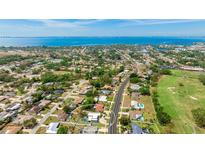 Stunning aerial view of a neighborhood with golf course, bay, and gorgeous landscaping around the home at 504 Whitfield Ave, Sarasota, FL 34243