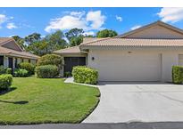 Charming home with manicured lawn, tile roof, and an attached two-car garage at 7205 Wood Creek Dr # 16, Sarasota, FL 34231