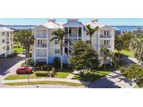 Beautiful condominium building boasts white balconies, lovely landscaping, and a tranquil waterfront view at 7810 34Th W Ave # 103, Bradenton, FL 34209