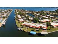 Aerial view of waterfront condo community with boat docks and easy access to the open bay waters at 9619 Valencia Cv, Bradenton, FL 34210