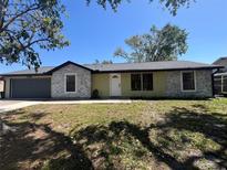 Charming single-story home with a two-car garage, stone accents, and a well-manicured lawn at 2816 N Lockwood Meadows Blvd, Sarasota, FL 34234