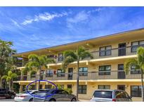 Condo building featuring multiple floors with balconies and tropical landscaping at 305 30Th Ave W # A104, Bradenton, FL 34205
