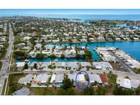 A beautiful aerial view of a waterfront property in a coastal community with nearby access to open water at 415 63Rd St, Holmes Beach, FL 34217