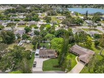 An aerial view of a home with mature landscaping, a lengthy drive and nearby views of the lake at 4619 20Th W Ave, Bradenton, FL 34209