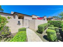 Inviting front entrance with a gate and lush landscaping, offering a charming approach to the home at 5309 Myrtle Wood Rd # 43, Sarasota, FL 34235