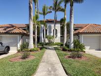 Beautiful condo exterior with lush landscaping, tiled roof, and inviting walkway at 6611 Grand Estuary Trl # 105, Bradenton, FL 34212