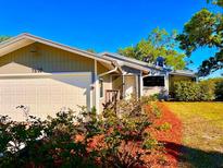 Charming one-story home showcasing a well-manicured front yard and an attached garage with lush landscaping at 7314 Mauna Loa Blvd, Sarasota, FL 34241