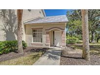 Charming front entrance with a pathway, window, and neatly landscaped surroundings at 7687 Sweetbay Cir # 7687, Bradenton, FL 34203