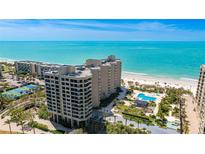 Stunning aerial view of a beachfront condominium complex with a pool and private beach access at 1211 Gulf Of Mexico Dr # 309, Longboat Key, FL 34228