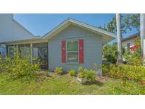 Charming single-story home with red window shutters and well-maintained landscaping at 1765 7Th St, Sarasota, FL 34236