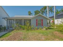 Charming single-story home with red window shutters and a screened porch at 1765 7Th St, Sarasota, FL 34236