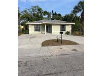 Charming single-story home with a spacious driveway and tropical landscaping at 2510 N Osprey Ave, Sarasota, FL 34234