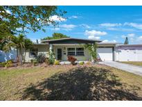 Charming single-story home featuring a well-manicured lawn and attached garage at 3828 20Th N St, St Petersburg, FL 33714