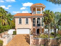 Stunning Mediterranean home with a tower, terracotta roof, and lush landscaping at 4001 5Th Ave, Holmes Beach, FL 34217