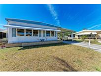 Charming single-story home with a carport and awnings over the windows at 5619 Bayshore Rd # 423, Palmetto, FL 34221
