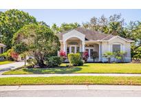 Charming single-story home featuring a well-manicured front yard with lush landscaping and an inviting entrance at 6602 Peach Tree Creek Rd, Bradenton, FL 34203