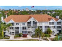 Multi-Gathering building with beautiful landscaping, open balconies, and stairs, plus city views and palm trees at 850 S Tamiami Trl # 207, Sarasota, FL 34236