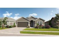 Charming one-story home featuring a two-car garage, neutral stucco, decorative stone accents and beautifully landscaped yard at 8760 Windlass Cv, Parrish, FL 34219