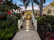 Inviting front entrance with illuminated steps, lush landscaping, and double door entry at 3322 Bayou Rd, Longboat Key, FL 34228